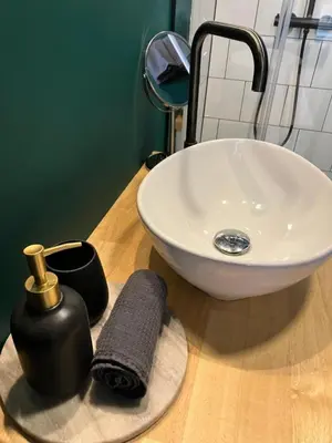 a bathroom with a sink and a towel on a counter at Living History - Suikernest in Antwerp