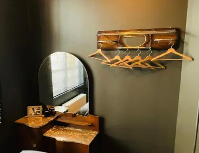 a bathroom with a mirror and a sink with hangers at Living History - Suikernest in Antwerp