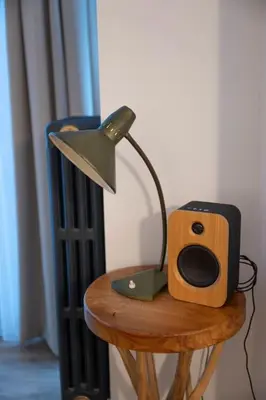 a lamp and a speaker on a wooden table at Chic 3-BR Oasis in Ghent - Stylish Interiors in Ghent