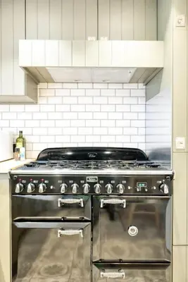 a kitchen with a stove top oven in a kitchen at Chic 3-BR Oasis in Ghent - Stylish Interiors in Ghent
