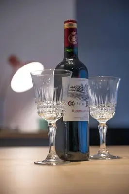 a bottle of wine and two glasses on a table at Chic 3-BR Oasis in Ghent - Stylish Interiors in Ghent