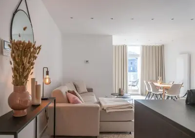 a living room with a couch and a table at Wonderful central 2BR Ghent apt w view on Leie in Ghent