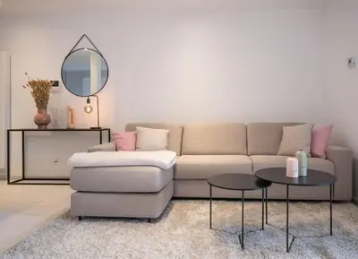 a living room with a couch and a mirror at Wonderful central 2BR Ghent apt w view on Leie in Ghent