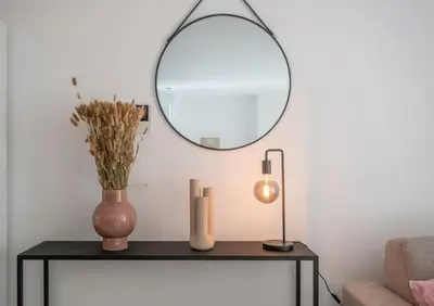 a living room with a table with a mirror at Wonderful central 2BR Ghent apt w view on Leie in Ghent