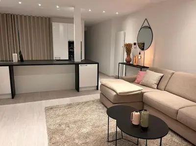 a living room with a couch and a table at Wonderful central 2BR Ghent apt w view on Leie in Ghent