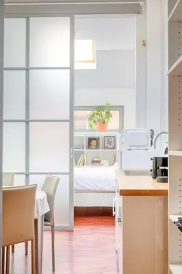 a room with a bed and a table and chairs at Cozy Retreat with Sauna near Gent-St-Pieters in Ghent