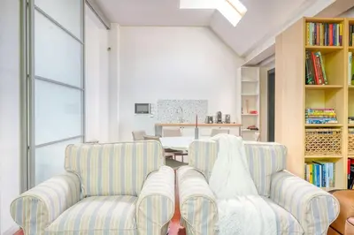a living room with two chairs and a table at Cozy Retreat with Sauna near Gent-St-Pieters in Ghent