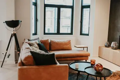 a living room with a couch and a table at Modern home near Ghent - Easy Access, Ideal Living in Ghent
