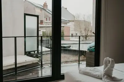 a bedroom with a window looking out at a balcony at Modern home near Ghent - Easy Access, Ideal Living in Ghent