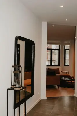 a mirror on a shelf in a living room at Modern home near Ghent - Easy Access, Ideal Living in Ghent
