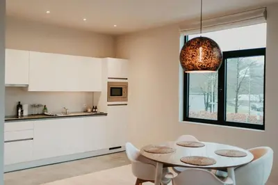 a kitchen with a table and chairs and a window at Modern home near Ghent - Easy Access, Ideal Living in Ghent