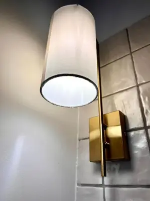a light attached to a wall with two lights at Chez Gianni & Stéphanie - A cozy and elegant Studio in Brussels in Brussels