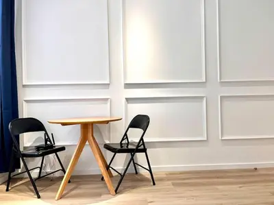 a table and two chairs in front of a wall at Chez Gianni & Stéphanie - A cozy and elegant Studio in Brussels in Brussels