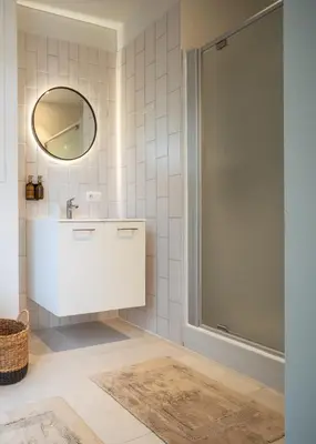 a bathroom with a sink and a mirror at Mavue kamer met terras in Mechelen