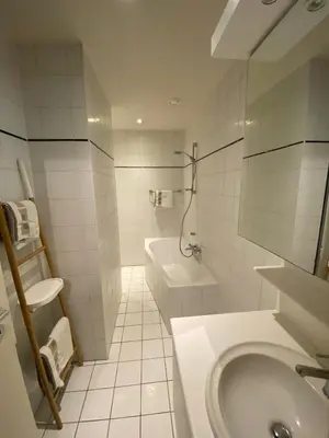 a white bathroom with a sink and a toilet at Studio Tintin in Brussels