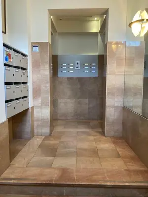 a bathroom with a walk in shower and a tile floor at Studio Tintin in Brussels