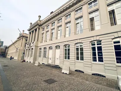 a building on a street with benches in front of it at Studio Tintin in Brussels