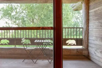 a room with a chair in front of a window at Cozy 4-Bedroom Chalet with Outdoor Spa in Zottegem in Zottegem
