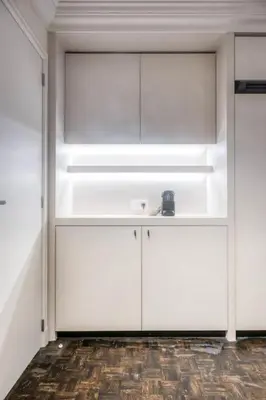 a room with white cabinets and a sink at Cozy Ghent Studio for 4 Guests in Ghent