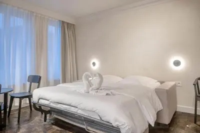 a bedroom with a white bed with a swan on it at Cozy Ghent Studio for 4 Guests in Ghent