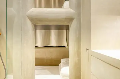 a white room with a bed and a curtain at Cozy Ghent Studio for 4 Guests in Ghent