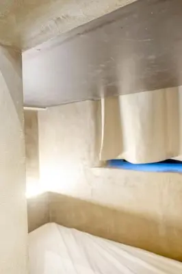a bed in a room with a white bedvisor at Cozy Ghent Studio for 4 Guests in Ghent