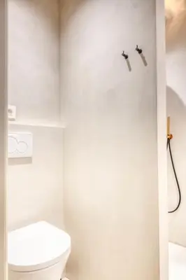 a white bathroom with a toilet and a shower at Chic 3P Retreat in Heart of Ghent in Ghent