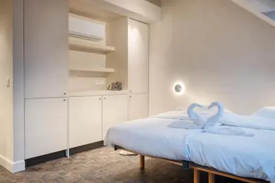 a bedroom with a bed with swans on it at Charming Attic Studio in Ghent in Ghent