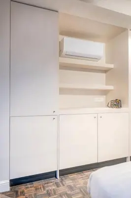 a bedroom with white cabinets and a bed at Charming Attic Studio in Ghent in Ghent
