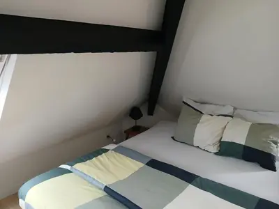 a bed with two pillows on it in a room at Flat at Relegem in Asse
