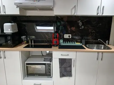 a small kitchen with a sink and a microwave at Flat at Relegem in Asse