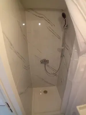 a bathroom with a shower with a glass door at Flat at Relegem in Asse