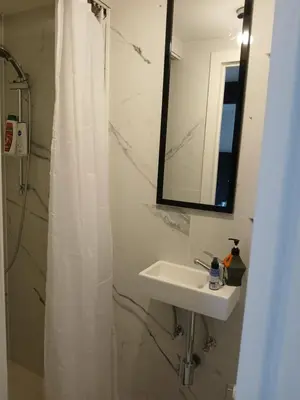a bathroom with a white shower curtain and a sink at Flat at Relegem in Asse