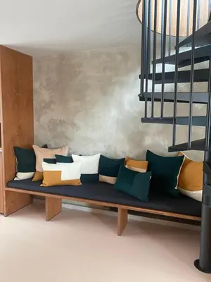 a couch with pillows on it in a room at Studio Conda in Antwerp