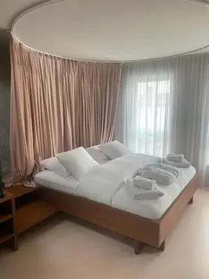 a bed in a room with a large window at Studio Conda in Antwerp
