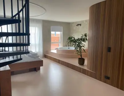 a bathroom with a tub and a potted plant at Studio Conda in Antwerp