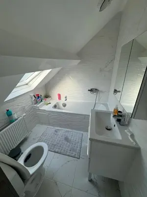 a bathroom with a toilet and a sink and a tub at Qozyroom in Brussels