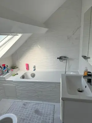 a white bathroom with a tub and a sink at Qozyroom in Brussels