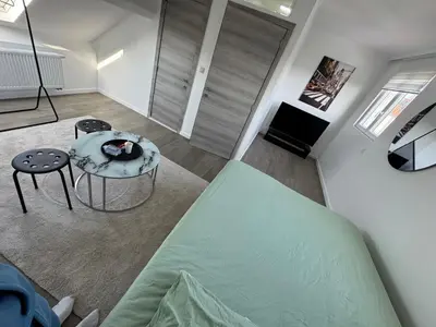 a living room with a bed and a table at Qozyroom in Brussels