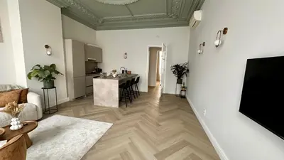a living room with a couch and a table at Urban Chic Apartment in the Heart of Mechelen in Mechelen