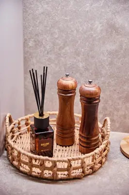 a basket with two coffee grinders and a box of sticks at Urban Chic Apartment in the Heart of Mechelen in Mechelen