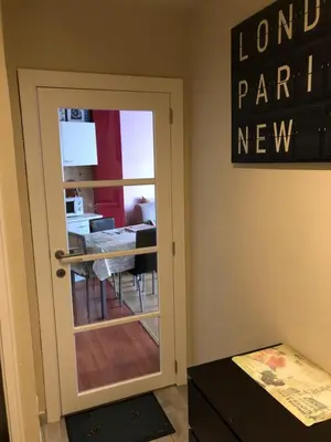 a door leading into a dining room with a table at One-bedroom Apartment near Atomium in Brussels