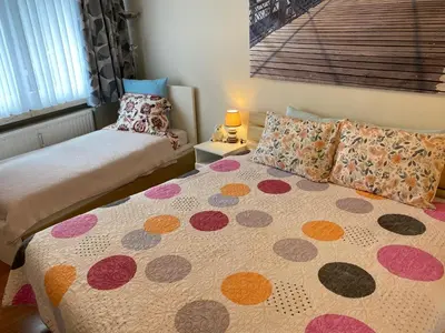 a bedroom with two beds with pillows and a bed sqor at One-bedroom Apartment near Atomium in Brussels
