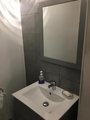 a bathroom with a white sink and a mirror at One-bedroom Apartment near Atomium in Brussels