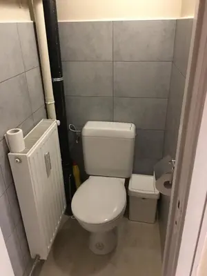 a small bathroom with a toilet and a sink at One-bedroom Apartment near Atomium in Brussels