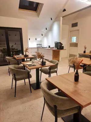 a room with tables and chairs in a building at Hotel Hallensis in Halle