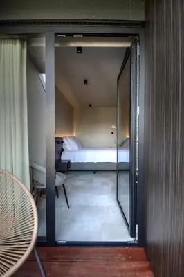 a room with a bed and a sliding glass door at Hotel Hallensis in Halle