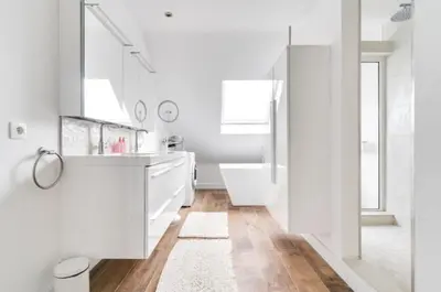 a white bathroom with a white tub and a sink at Espace moderne pouvant accueillir 3 personnes in Vilvoorde