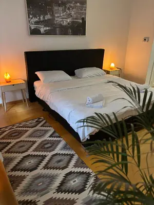a bedroom with a bed and a potted plant at L&L Residence in Brussels