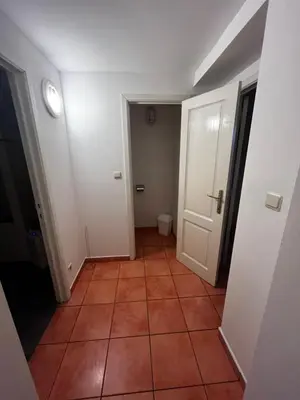 a hallway with a tile floor and a white door at L&L Residence in Brussels